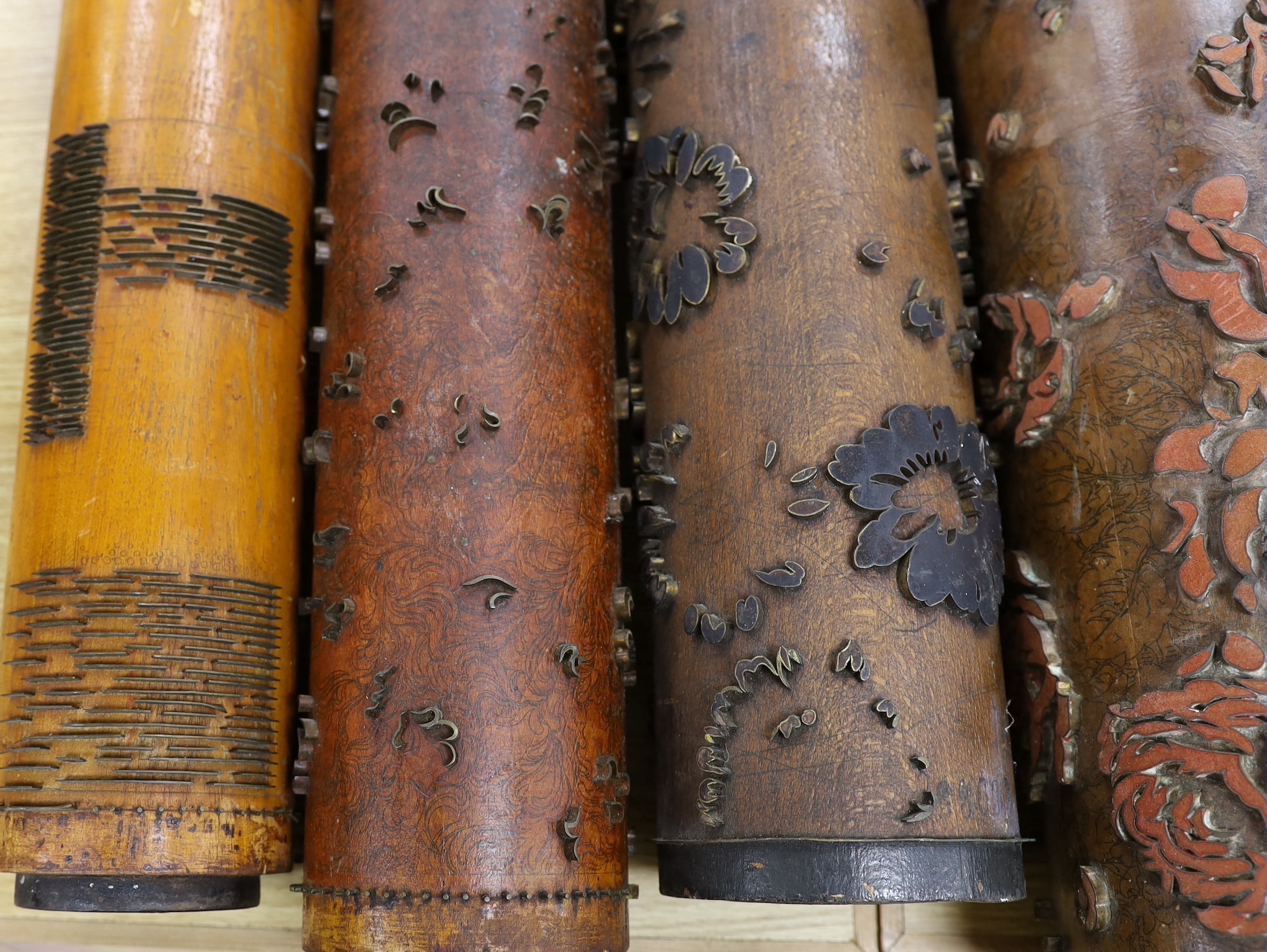 Five USA wooden print rollers for wallpaper, late 19th century, including a UWPC (United Wall Paper Craftsmen of North America) example, another stamped with serial numbers, longest 60.5cm